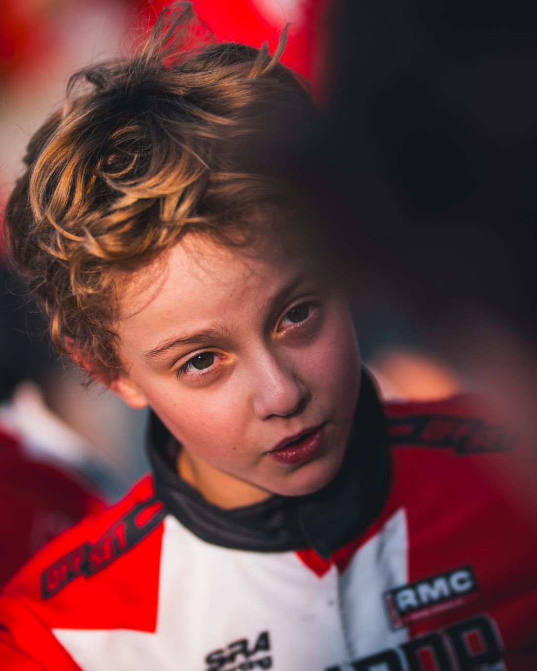 Close portrait of a young driver in the paddock