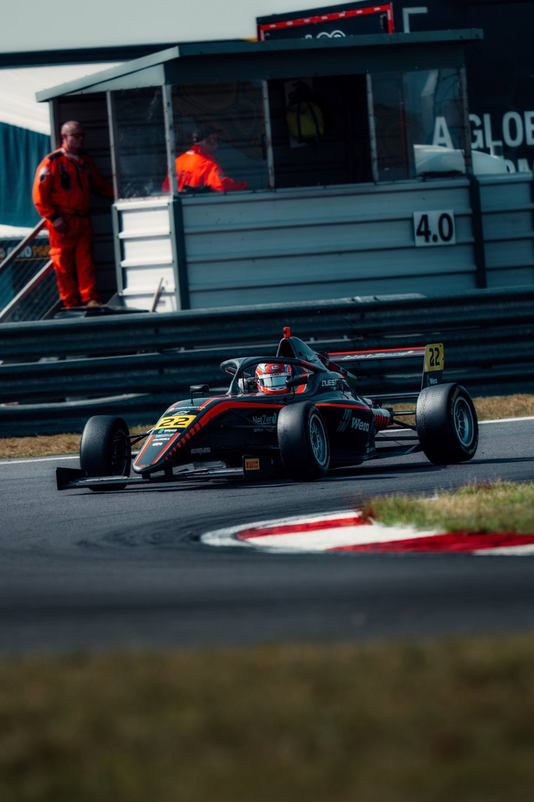 Car number 22 through the corner past marshals