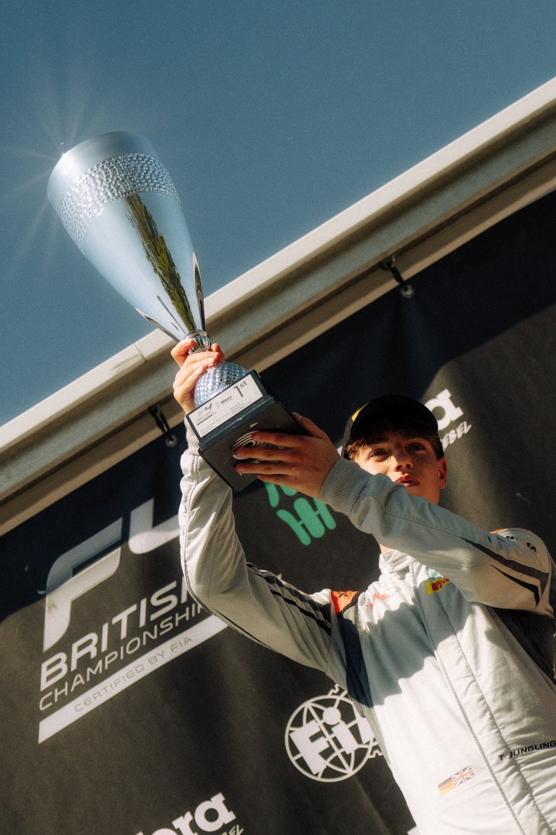 Race winner lifts the trophy on the podium