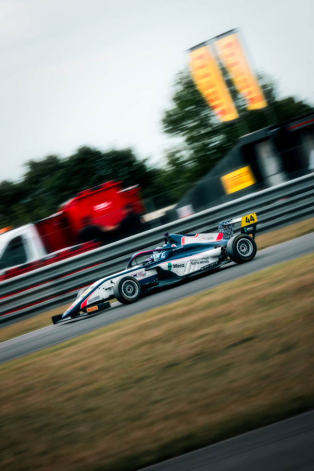 F4 car number 44 panning shot past Pirelli banners