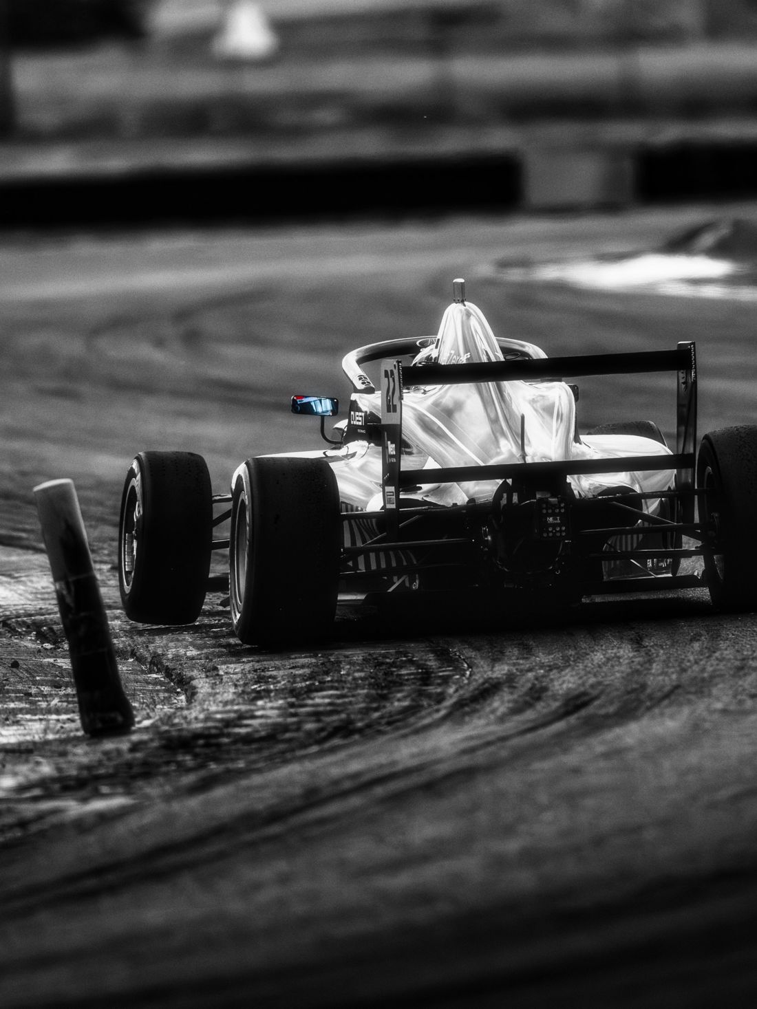 Car number 22 from behind through the chicane, black and white