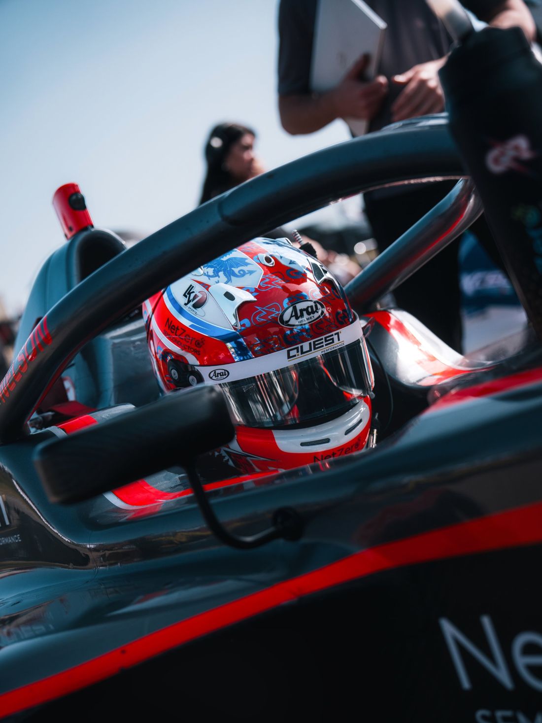 Driver's helmet framed by the halo on the grid