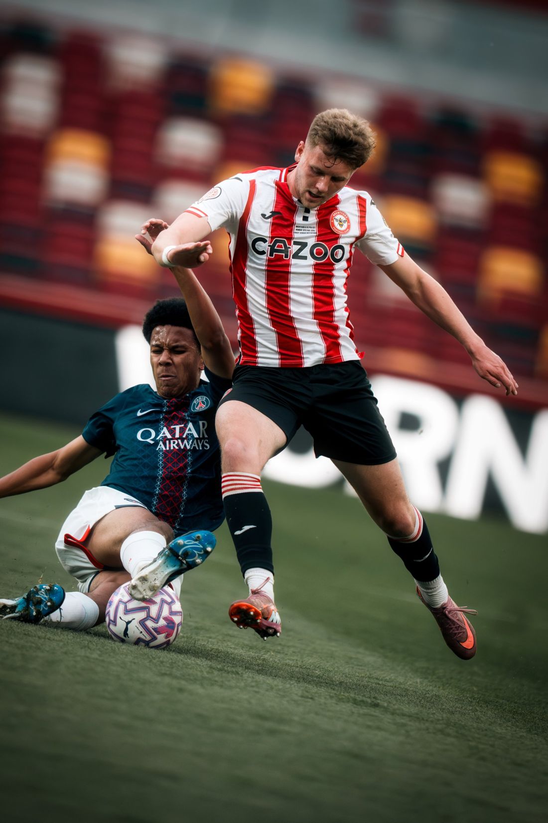 PSG player slides in on a Brentford attacker