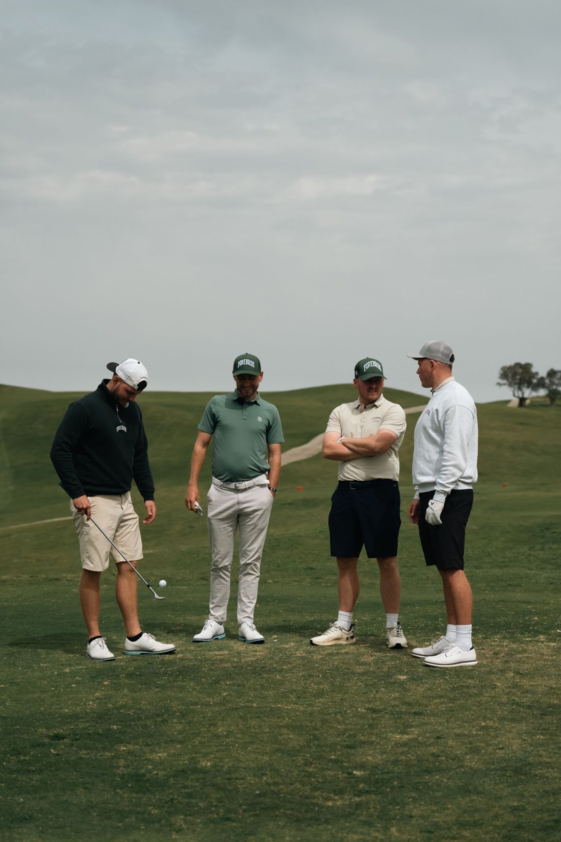 Four golfers in Forebros kit on the fairway