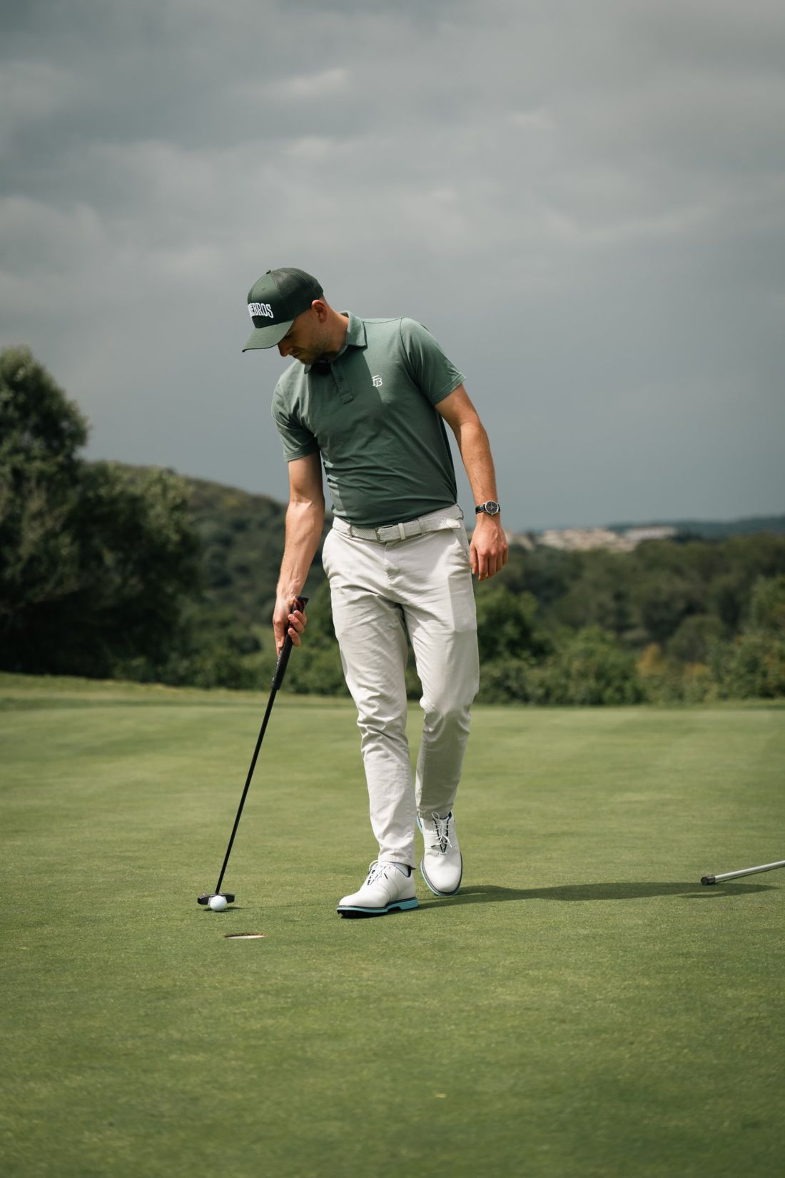 Golfer stands over a putt on the green