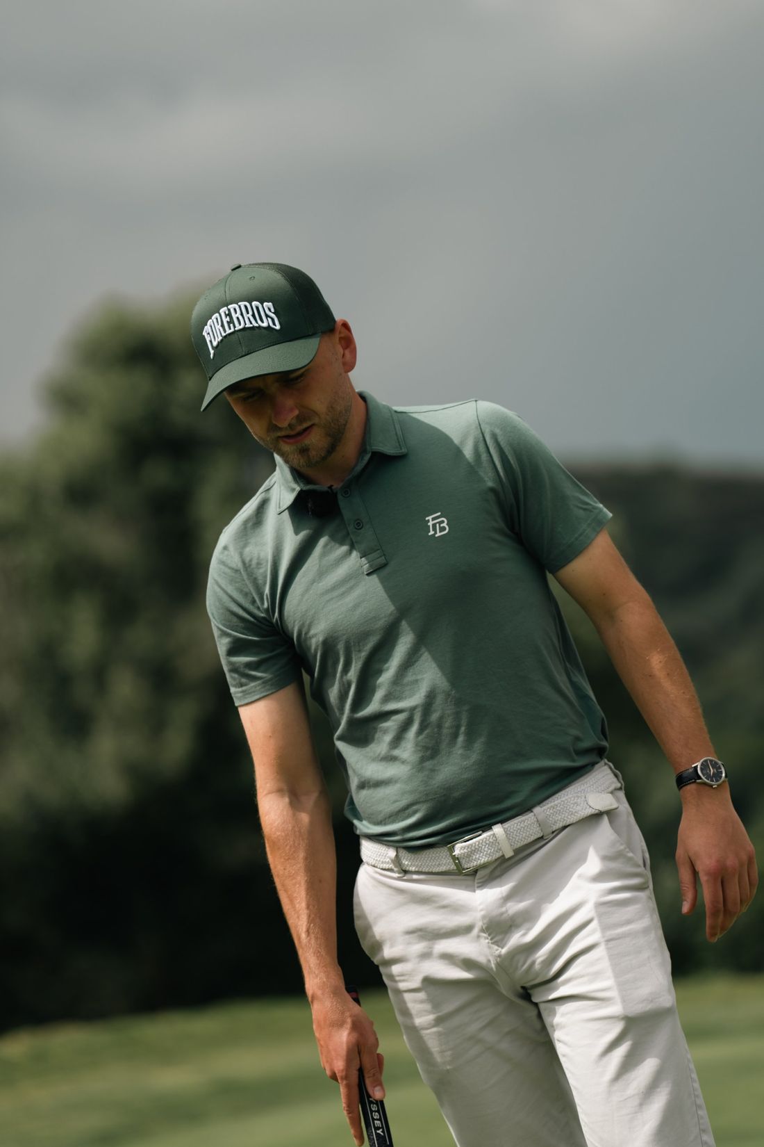 Golfer looks down at his putt