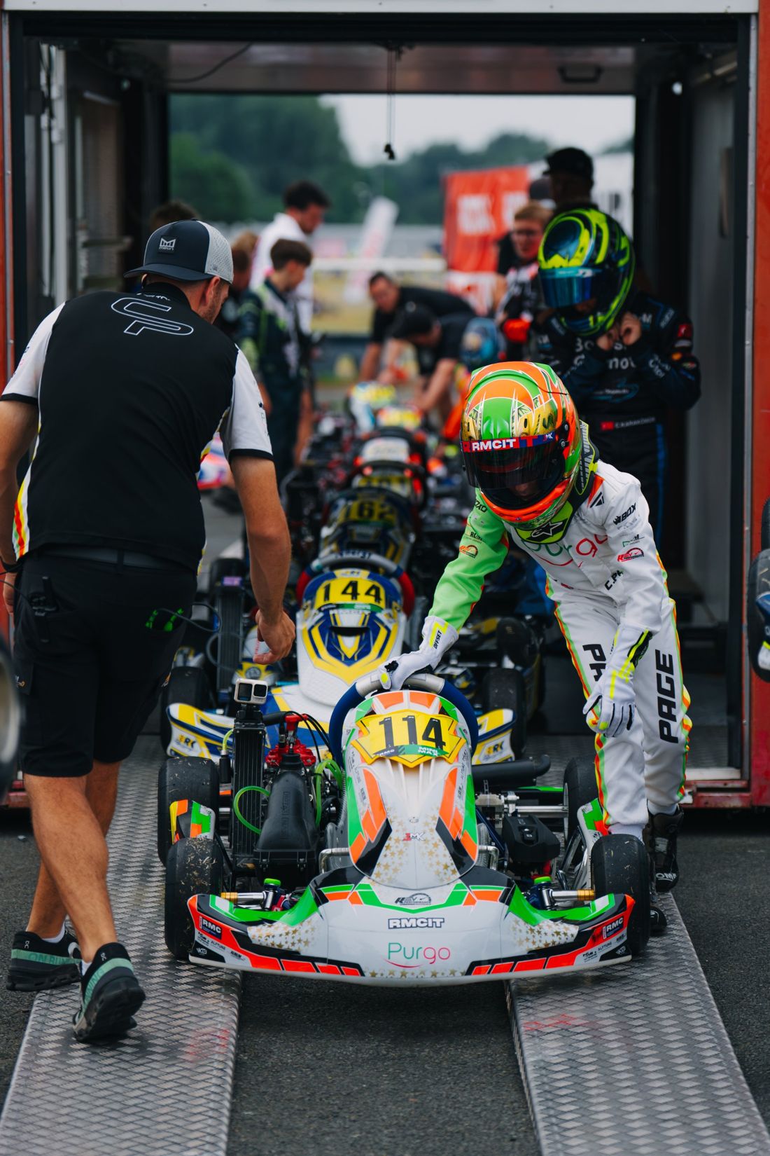 Charlie Page pushes kart 114 down the ramp to the grid