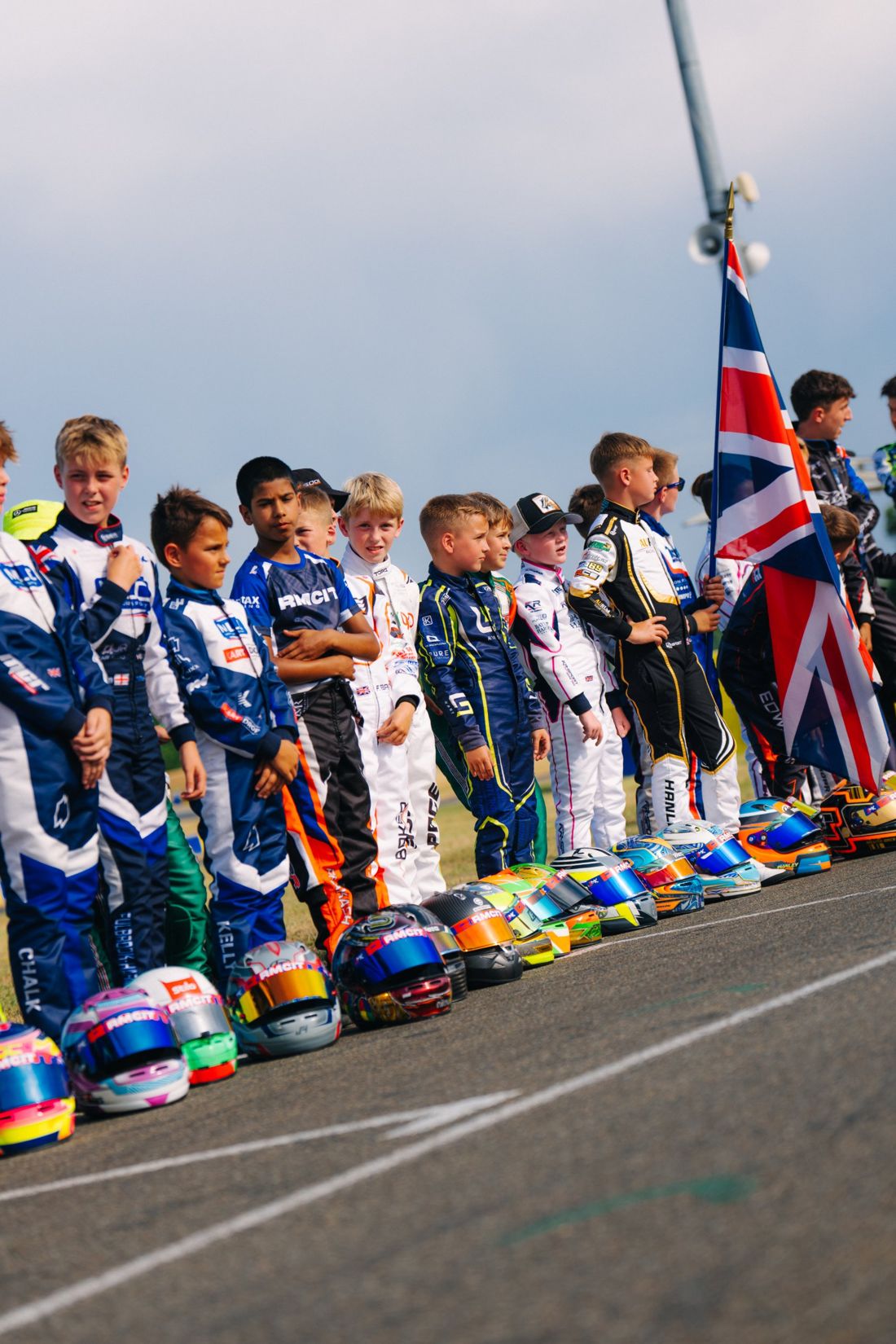 Drivers line up with their helmets on the grid