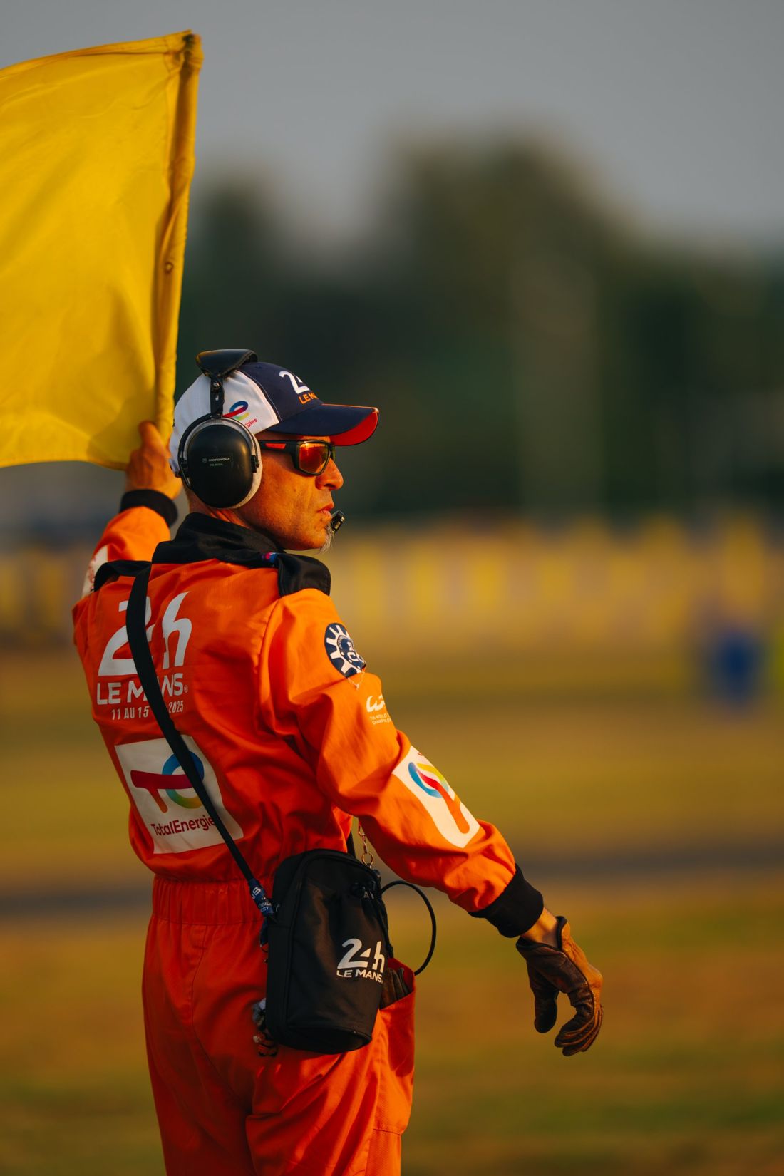 Le Mans marshal holds a yellow flag