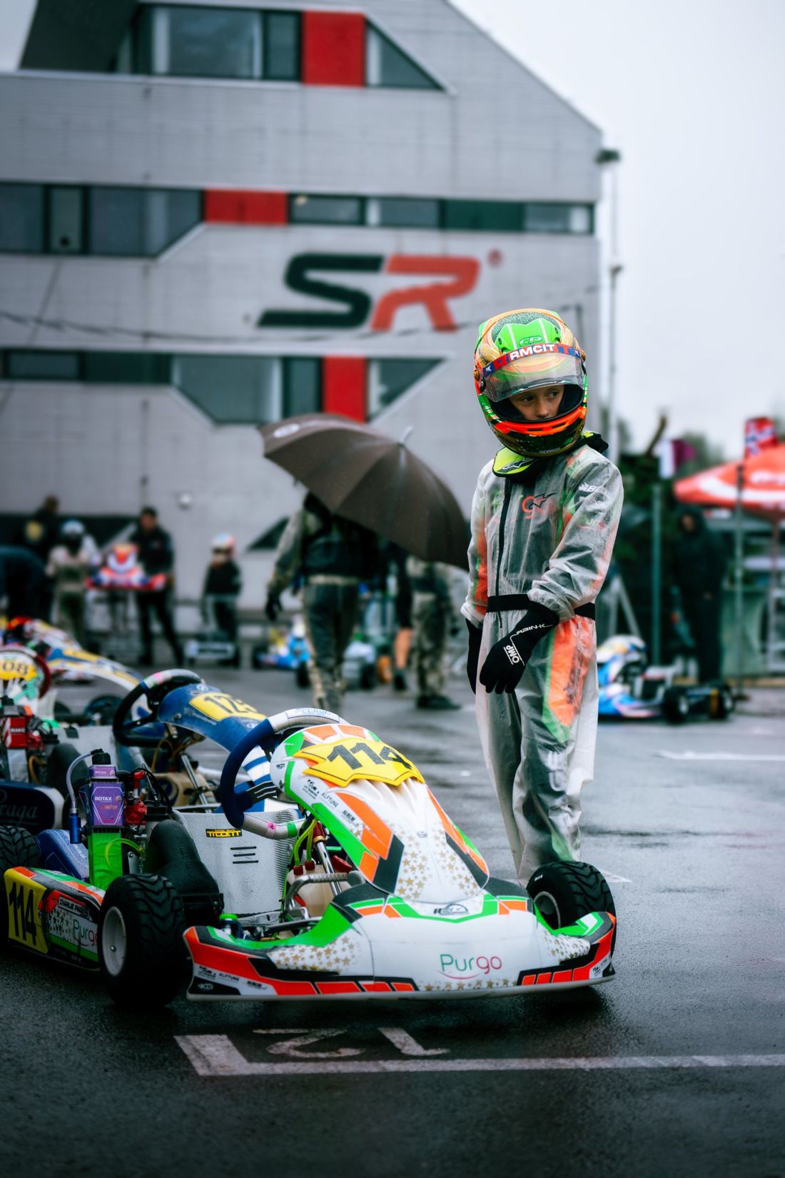 Charlie Page waits by his kart in the rain