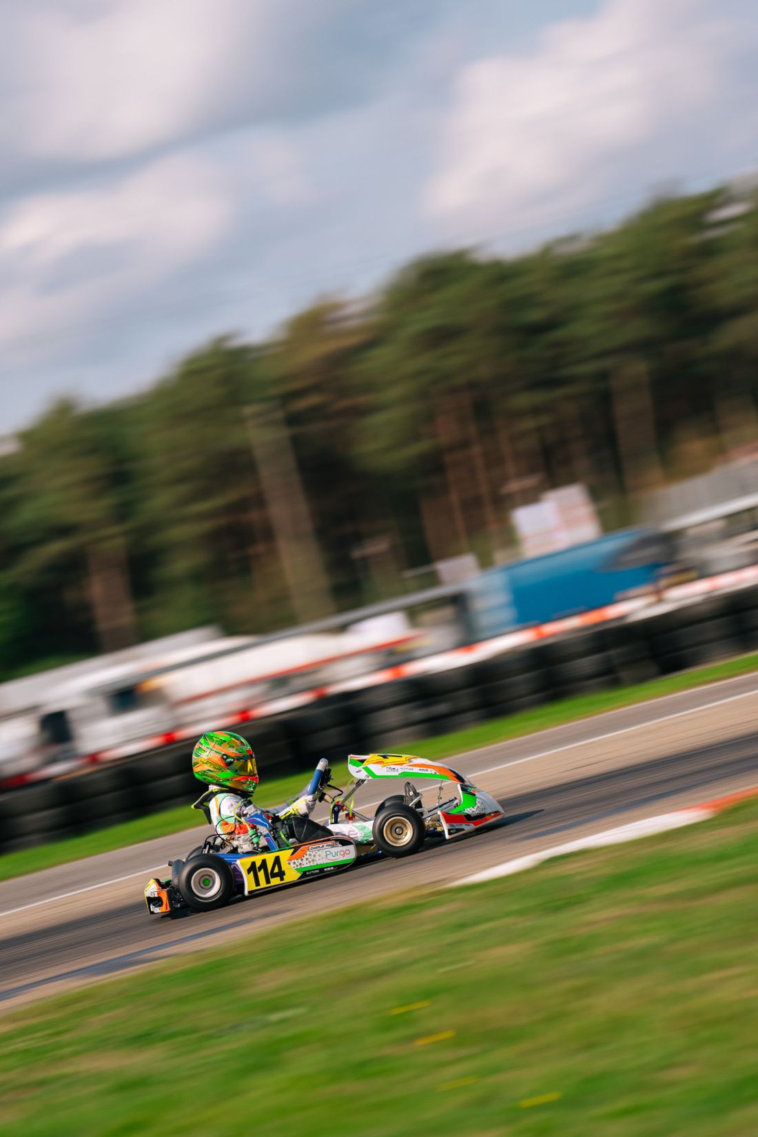 Panning shot of kart 114 under a cloudy sky