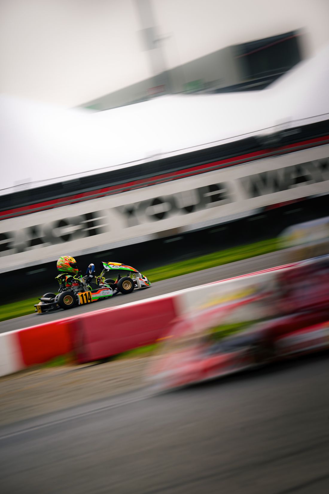 Kart 114 past the Race Your Way banner